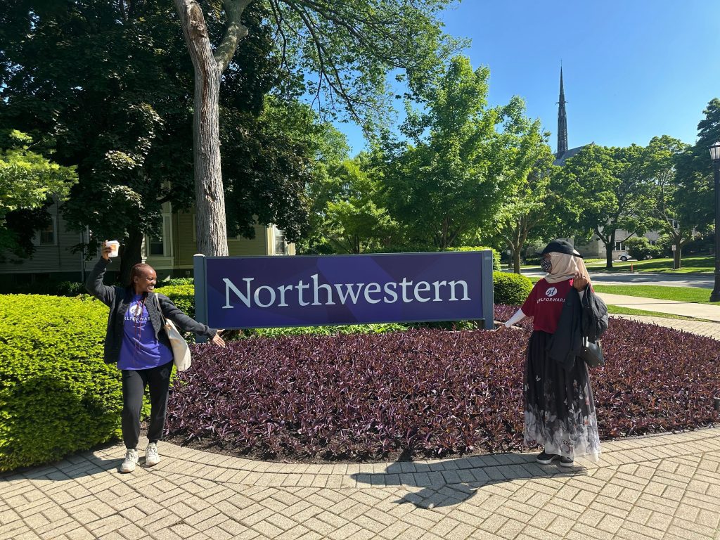 Two women standing in front of a Northwestern